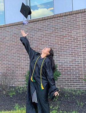Graduate throwing her cap in the air