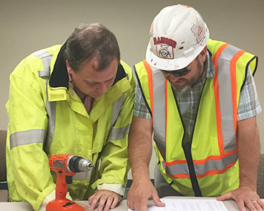 Construction workers studying plans